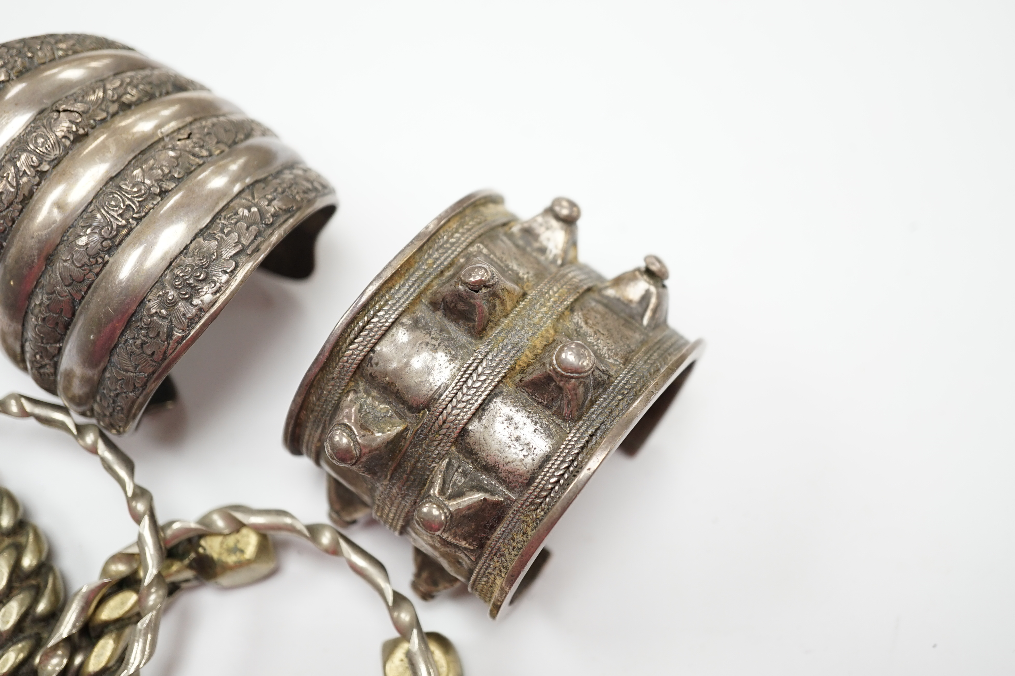 Six assorted Egyptian bracelets, including white metal bangles and two white metal cuff bracelets. Fair condition.